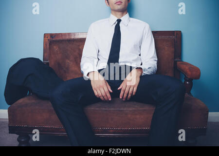 Young Woman relaxing on a sofa Banque D'Images