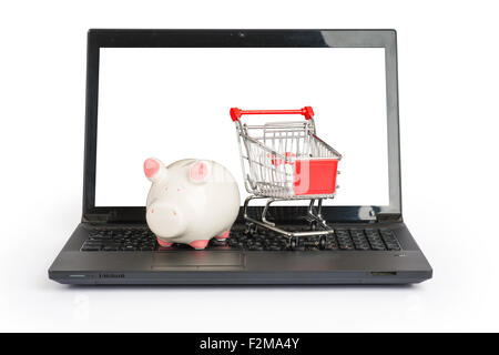 Panier et piggy bank on laptop Banque D'Images
