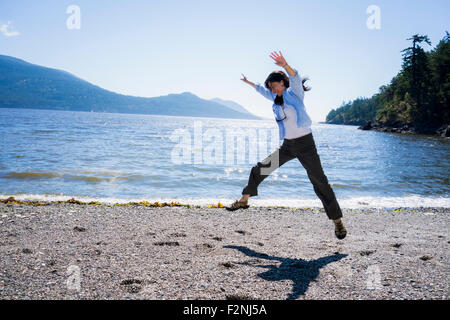 Femme japonaise faisant la roue sur la plage Banque D'Images