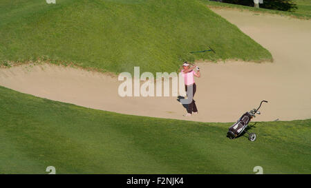 Caucasian woman in sand trap on golf course Banque D'Images