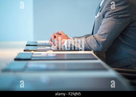 Caucasian businessman sitting at conference table Banque D'Images