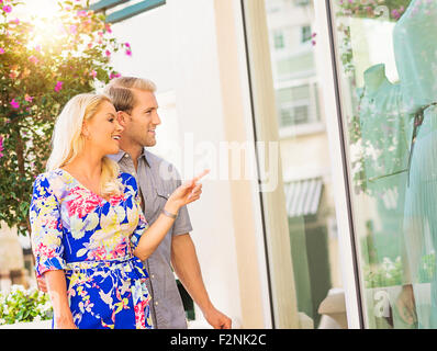 Caucasian couple window shopping store extérieur Banque D'Images