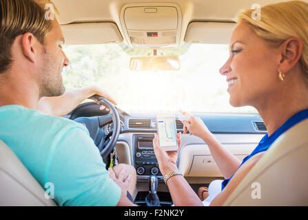 Caucasian couple using cell phone in car navigation Banque D'Images