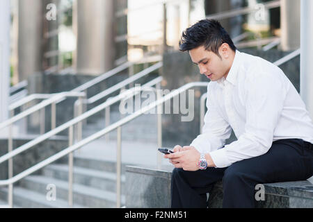 Mixed Race woman near staircase Banque D'Images