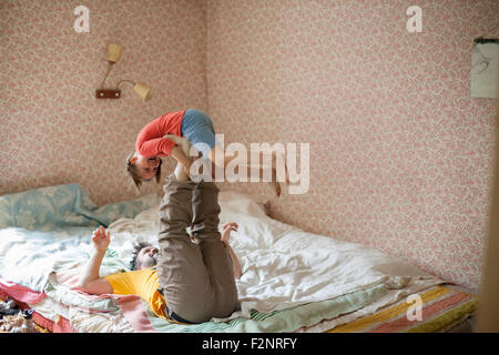 Caucasian father and daughter playing on bed Banque D'Images