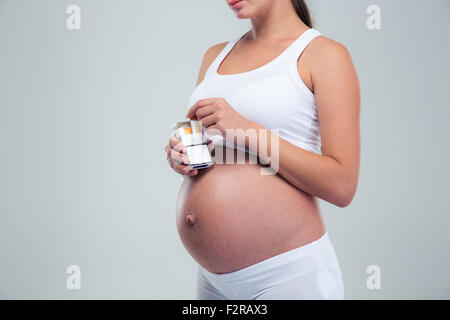 Closeup portrait of a pregnant woman holding cigarette isolé sur fond blanc Banque D'Images