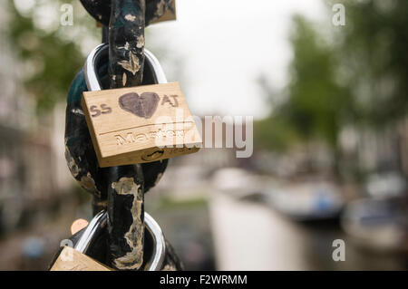 Cadenas attachés à la chaîne d'un pont sur un canal à Amsterdam, à gauche par les amateurs de montrer leur amour. Banque D'Images