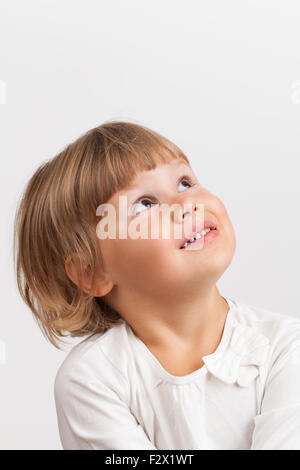 Cute little girl caucasienne, closeup portrait sur fond gris clair Banque D'Images