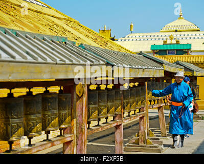 L'homme de Mongolie en vêtements traditionnels, Deel, tourner les roues de prière, monastère de Gandan, Ulaanbaatar, Mongolie Banque D'Images