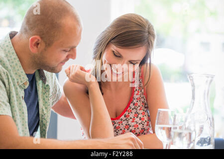 Un couple, homme et femme assis dans un restaurant à un menu. Banque D'Images