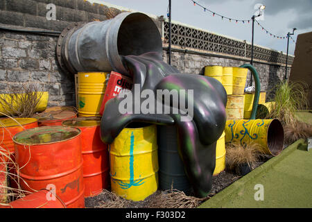 Dismaland la stupéfaction, Parc, organisé par l'artiste Banksy . Fake écoulement d'huile sur un baril, au Crazy Golf (golf) Banque D'Images