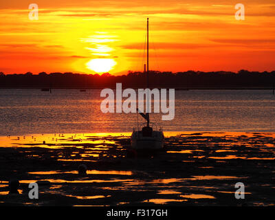 Coucher de soleil sur le port de Portsmouth, Hampshire, Angleterre. Vu de la côte de l'île de baleine Creek. Banque D'Images