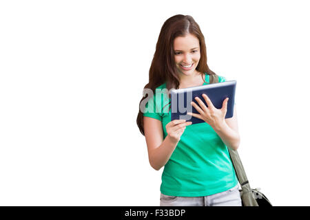 Image composite de l'étudiant en utilisant son tablet in library Banque D'Images