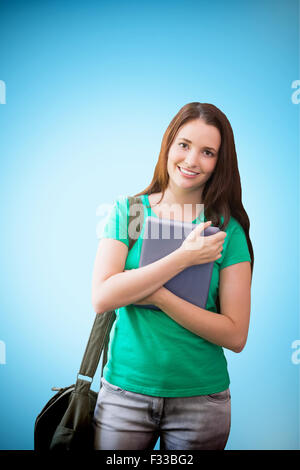 Image composite de l'étudiant en utilisant son tablet in library Banque D'Images