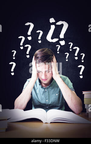 Image composite de student sitting in library reading Banque D'Images