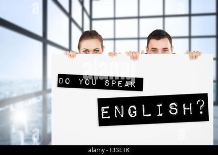 Image composite de partenaires d'affaires de se cacher derrière un signe Banque D'Images