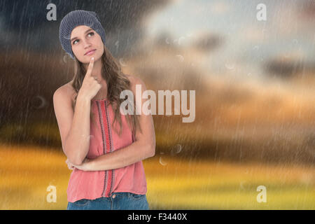 Composite image of woman wearing hat avec le doigt sur le menton Banque D'Images
