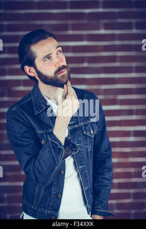 Beau réfléchie with hand on chin man looking away Banque D'Images