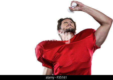 Joueur de football américain en maillot rouge verser de l'eau sur le visage Banque D'Images