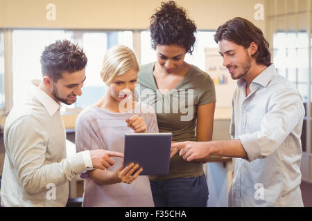 Collègues using digital tablet in office Banque D'Images