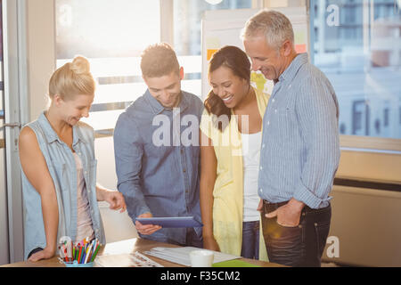 Business people looking at digital tablet in meeting room Banque D'Images