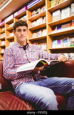 Portrait of young man with book Banque D'Images