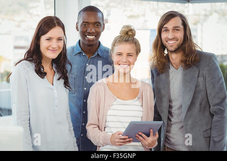 Portrait of smiling business team with woman holding digital tablet Banque D'Images
