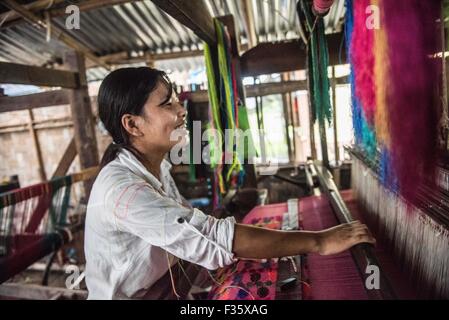 Une femme travaille dans un métier, dans l'État de Kachin, au Myanmar Banque D'Images