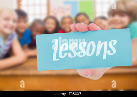 Les élèves des enseignements contre cute smiling at camera in classroom Banque D'Images