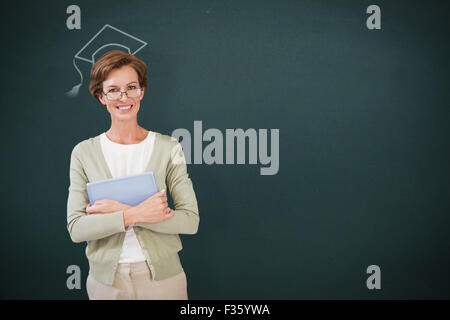 Image composite de teacher holding tablet pc at library Banque D'Images