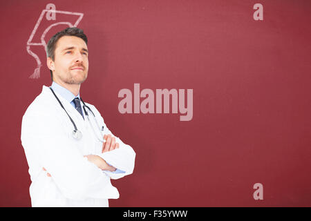 Image composite de handsome young doctor with arms crossed Banque D'Images