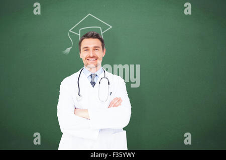 Image composite de handsome young doctor with arms crossed Banque D'Images