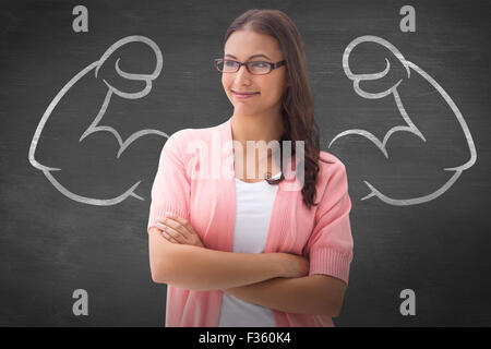 Image composite de jolie brunette smiling with arms crossed Banque D'Images