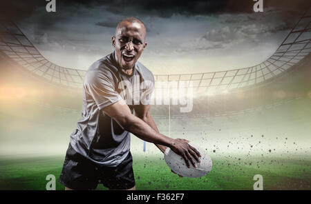 Image composite de portrait de sportif agressif à jouer au rugby Banque D'Images