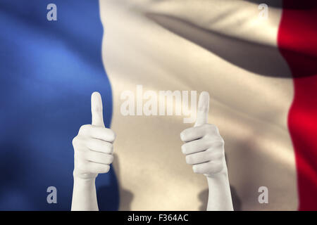 Image composite de businesswomans hands showing Thumbs up Banque D'Images