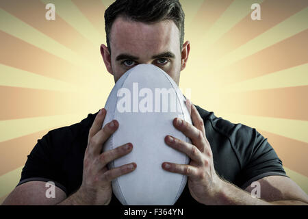 Image composite de difficiles rugby player holding ball Banque D'Images