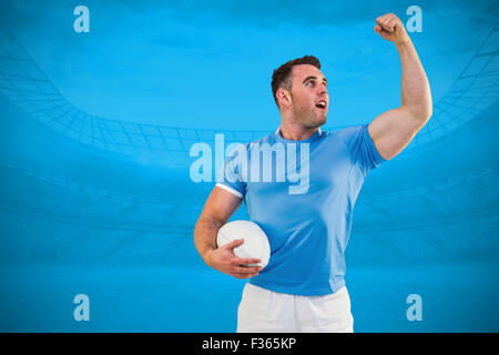 Image composite de rugby player cheering avec la balle Banque D'Images