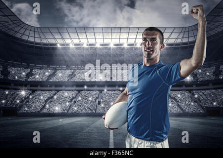 Composite image rugby player flexing muscles Banque D'Images