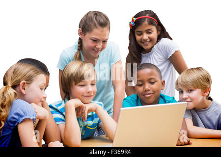 Image composite de cute pupils using tablet computer in library Banque D'Images