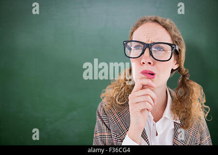 Image composite de hipster geek woman thinking with hand on chin Banque D'Images