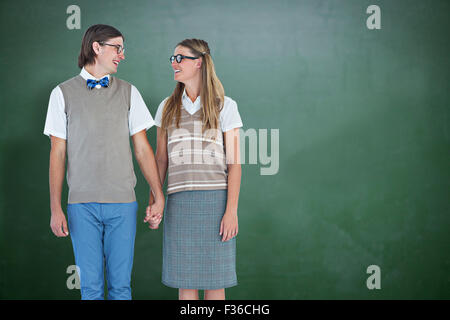 Image composite de hipster geek couple holding hands at Banque D'Images