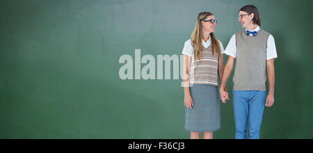 Image composite de hipster geek couple holding hands at Banque D'Images