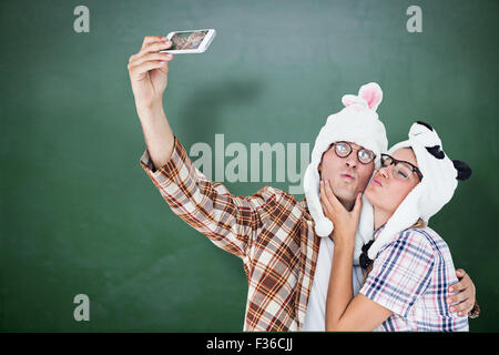 Image composite de hipster geek couple avec selfies smart phone Banque D'Images