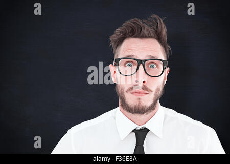 Image composite de geeky young businessman looking at camera Banque D'Images