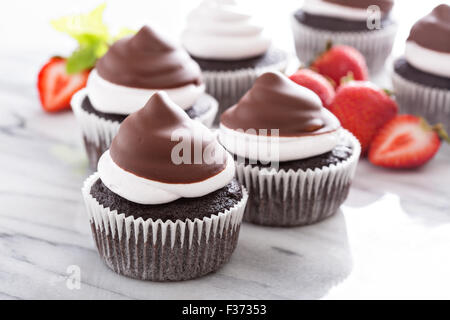 La meringue chocolat cupcakes avec glaçage au chocolat et fraises Banque D'Images