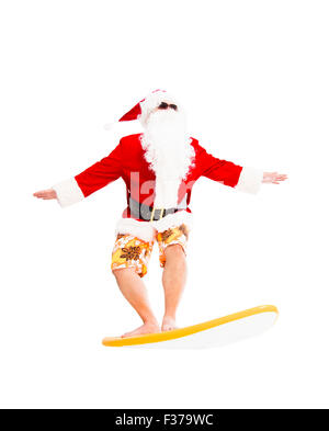 Happy Santa Claus surf avec surf board Banque D'Images