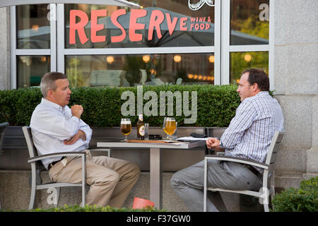 Grand Rapids, Michigan - deux hommes partagent beers dans un restaurant à l'extérieur de la salle à manger. Grand Rapids dispose de dizaines de brasseries artisanales. Banque D'Images