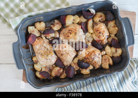 Le thym et citron rôti de cuisses de poulet avec l'ail écrasé de pommes de terre nouvelles et de betterave au vinaigre balsamique et huile d'olive Banque D'Images