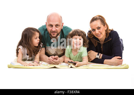 Happy Family lying down on blanket in a row isolé sur fond blanc Banque D'Images