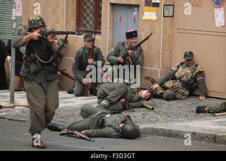 En tant que soldats en uniforme reconstitueurs de l'Armée de libération russe (OAK) assister à la reconstitution de l'insurrection de Prague 1945 à Prague, en République tchèque, le 9 mai 2015. L'Armée de libération russe également connu sous le nom de l'Armée de Vlasov est venu à l'aide de la République Tchèque Prague pour soutenir les insurgés soulèvement contre l'occupation allemande qui a débuté le 5 mai 1945. Banque D'Images